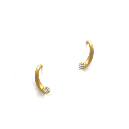 Gold hoop earrings with small diamonds on a white background