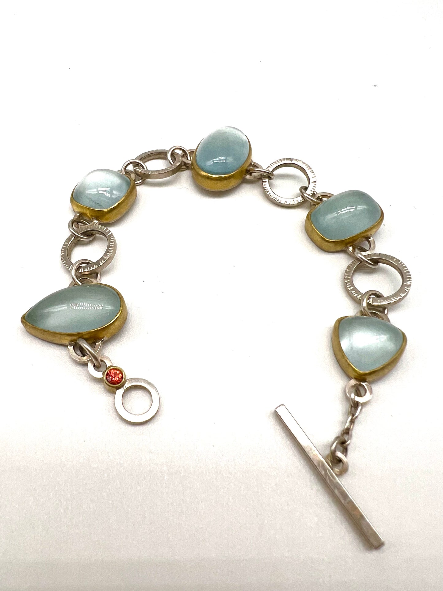 Cabochon Aquamarine, Orange Sapphire, 22kt Yellow Gold and Sterling Silver link bracelet